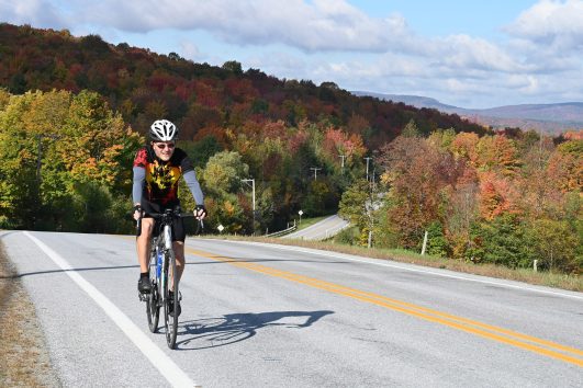 An experienced cyclist enjoying the rolling landscape as you pass through quiet towns and villages with Freewheeling Adventures.